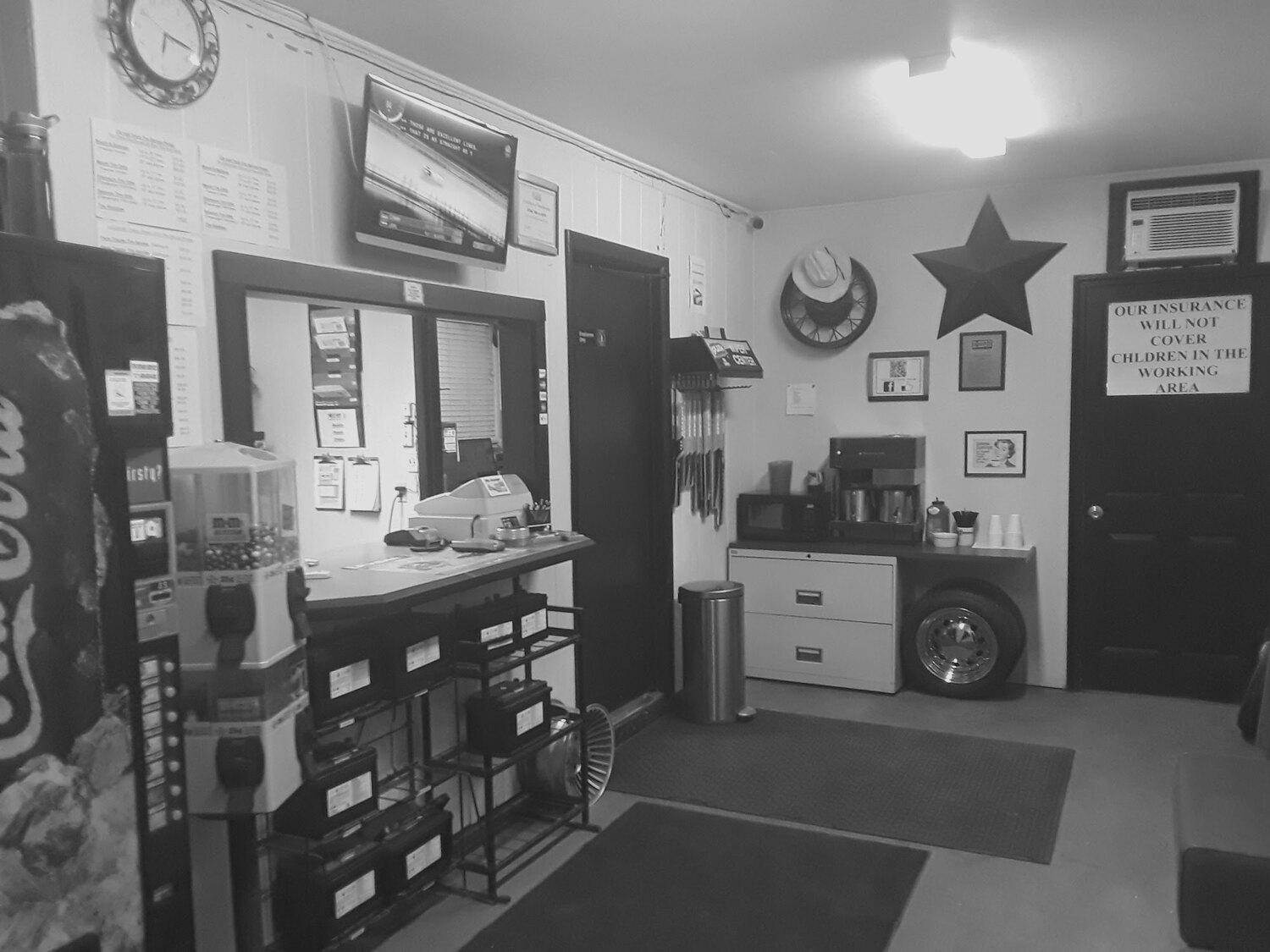 The front counter at Star Tire and Auto, with the price lists and the metal star on the wall