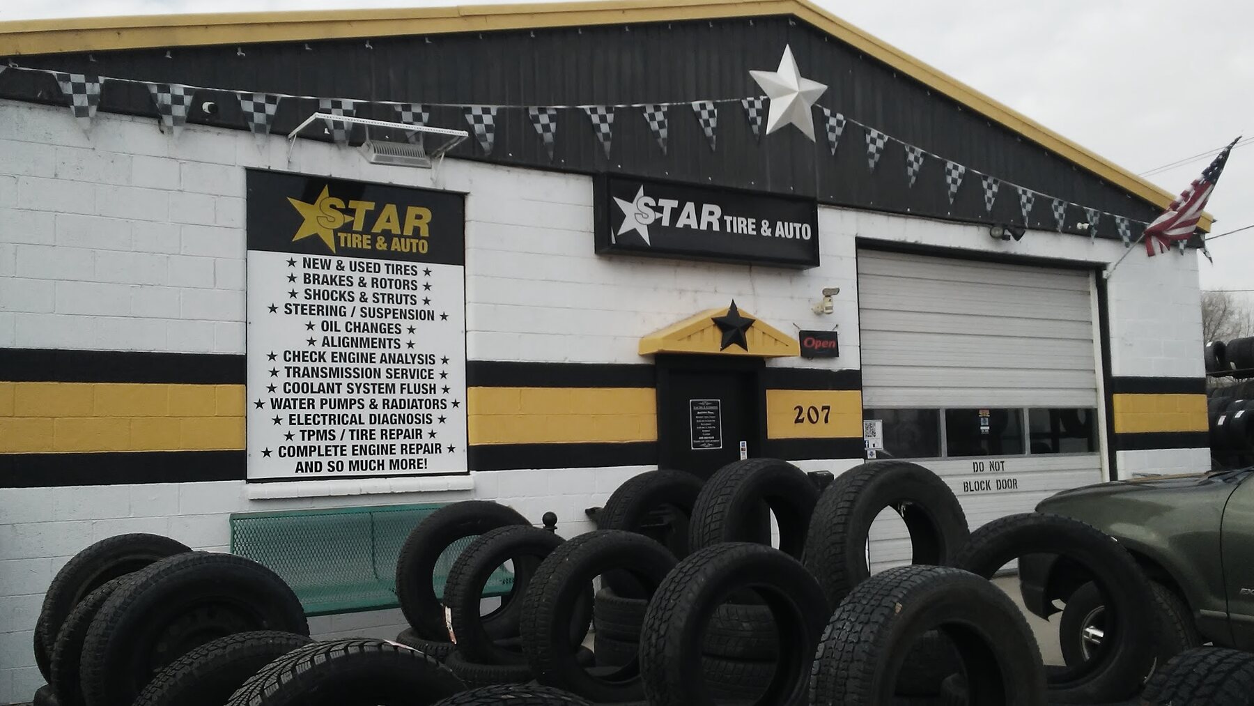 The Star Tire storefront and hand-painted service board, tire stacks in the lot
