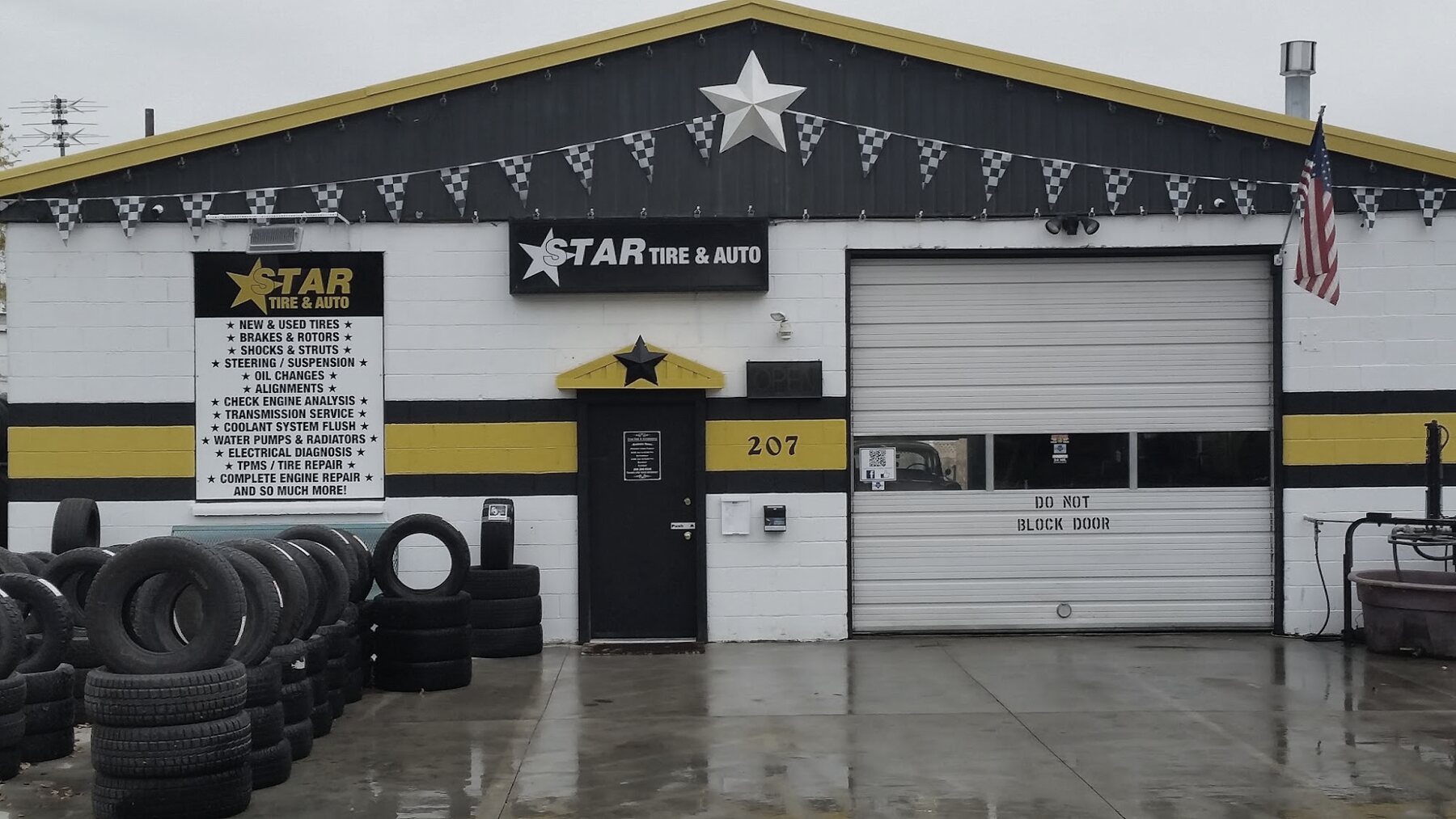 Star Tire and Auto storefront at 207 S Star Road on an overcast Idaho morning, tire stacks in the wet lot